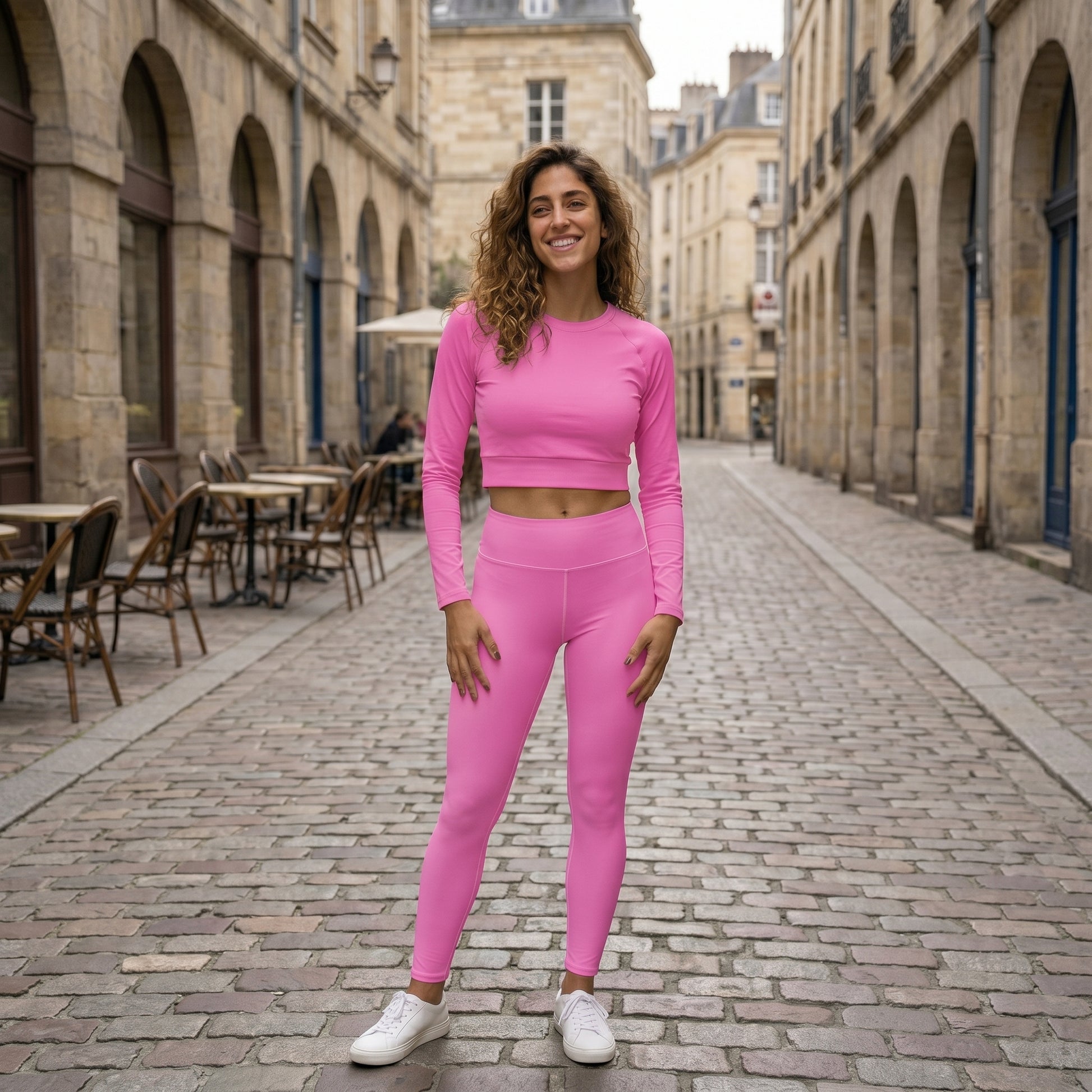 AMMOR PARIS bright pink recycled yoga leggings with a high‑waisted sculpting fit, shown on a model standing on a clean white background, emphasizing the smooth microfiber yarn, four‑way stretch performance fabric, raised waistband and sustainable minimal athleisure design ideal for yoga, training and everyday movement.