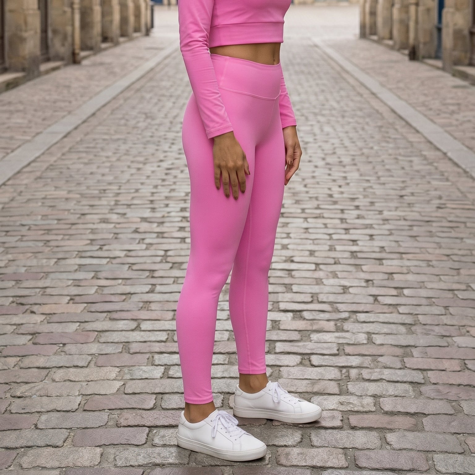 AMMOR PARIS bright pink recycled yoga leggings with a high‑waisted sculpting fit, worn by a model standing on a clean white background, emphasizing the smooth microfiber yarn, four‑way stretch performance fabric, raised waistband and sustainable minimal athleisure design; ideal for yoga, pilates, stretching, gym training and everyday comfort in modern activewear
