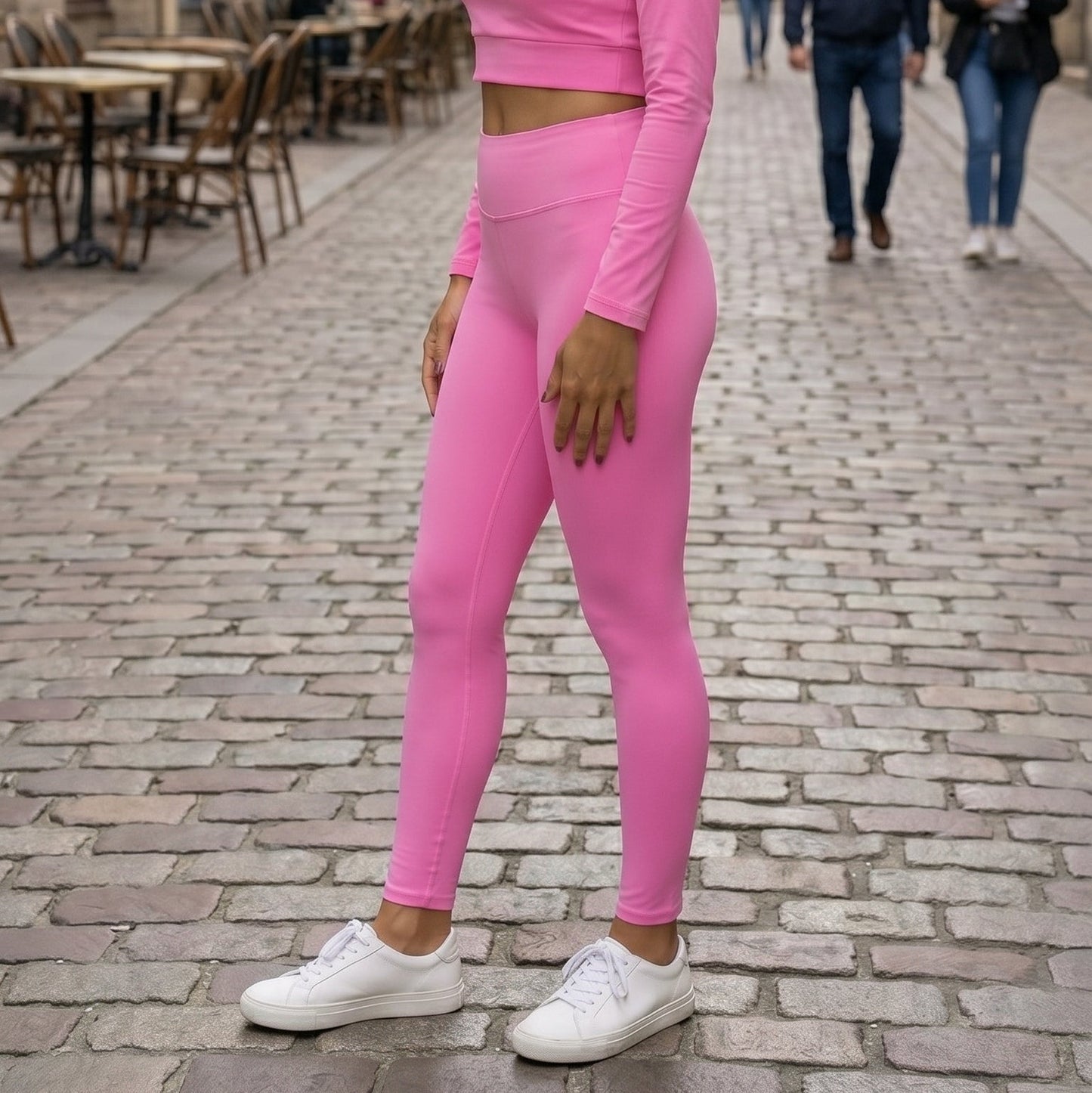 AMMOR PARIS bright pink recycled yoga leggings with a high‑waisted sculpting fit, worn by a model standing on a clean white background, showcasing the smooth microfiber yarn, four‑way stretch recycled performance fabric, raised supportive waistband and minimal sustainable athleisure silhouette; designed for yoga, pilates, stretching, gym workouts, active daily wear and eco‑conscious modern fashion.

