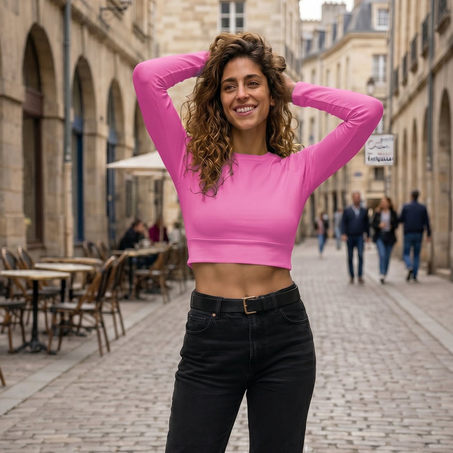 AMMOR PARIS recycled long‑sleeve crop top in bold pink, photographed flat on a deep black background to accentuate its UPF50+ recycled performance fabric, sculpted cropped silhouette, raglan sleeves and wide double‑layered waistband, embodying the brand’s elevated Paris‑born sustainable athletic design language.


